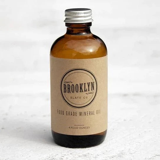 Brooklyn Slate Company- Food Grade Mineral Oil | A brown glass bottle with a simple brown label that reads "Brooklyn Slate Co. Food Grade Mineral Oil, 4 Fluid Ounces".