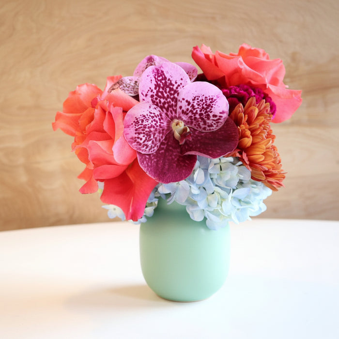 Fairy | Vased Arrangement | Close up highlighting the purple orchid and the pink/orange rose.